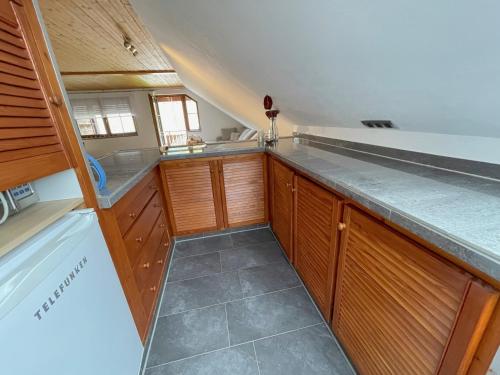 a kitchen with wooden cabinets and a counter top at Geräumiges Maisonette Apartment in Todtmoos