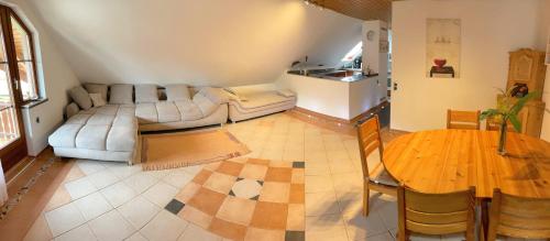 a living room with a couch and a table at Geräumiges Maisonette Apartment in Todtmoos