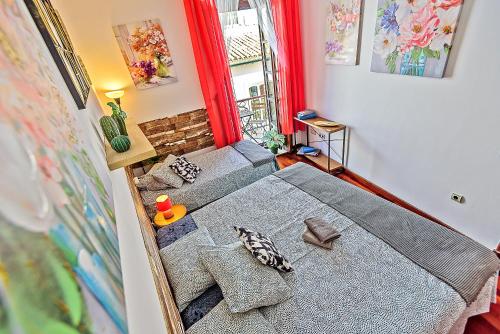 a small bedroom with two beds and a window at Ribera De Luxe Central Apartment with Ascensor in El Puerto de Santa María