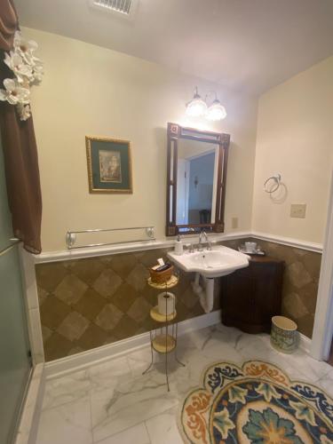 a bathroom with a sink and a mirror at The Cypress Inn in Conway