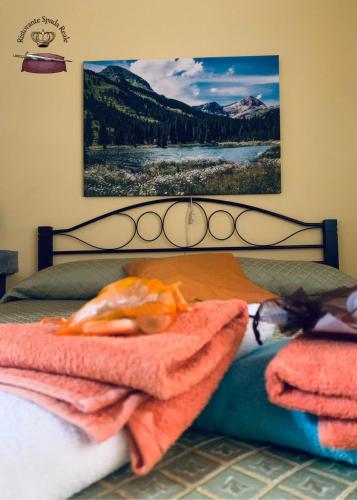 a bedroom with a bed with a picture on the wall at Spada Reale in Valdieri