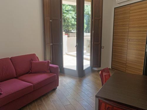 a living room with a couch and a table at Nuraghe Apartments in Teulada