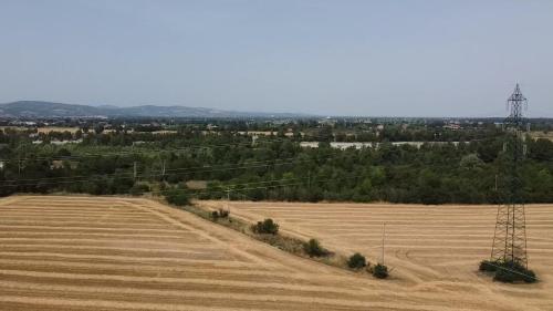 an aerial view of a field and power lines at Sala dell Estate Guest House in Secchia