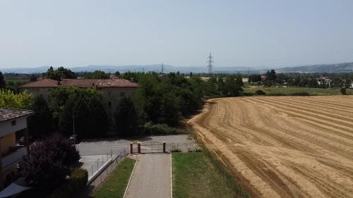 an aerial view of a field next to a house at Sala dell Estate Guest House in Secchia