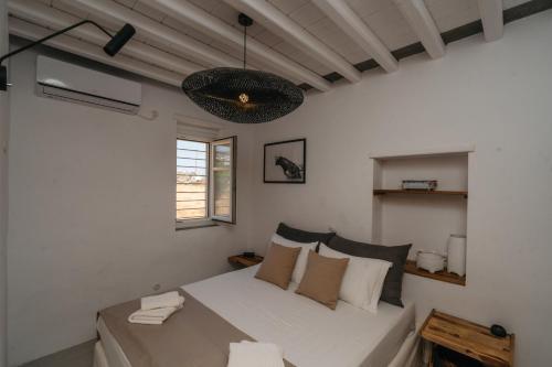 a bedroom with a bed in a white room at Aillia house in Sifnos