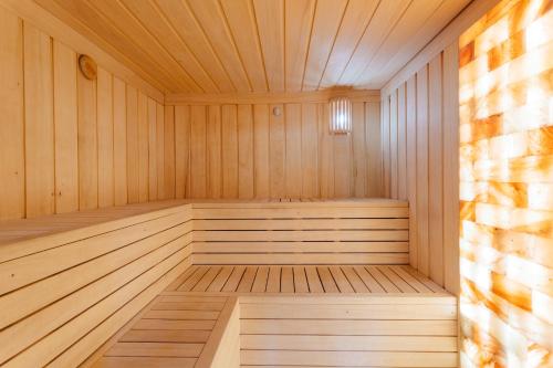 a wooden sauna with a wooden floor and ceiling at Hotel Marlene in Oščadnica
