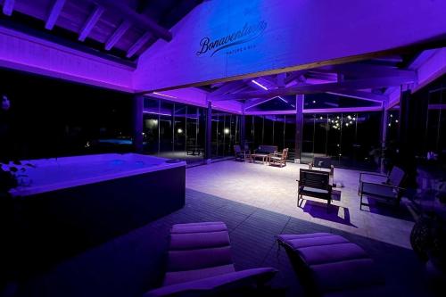 a room with purple lighting and chairs and tables at Agriturismo Bonaventura in Montefiascone