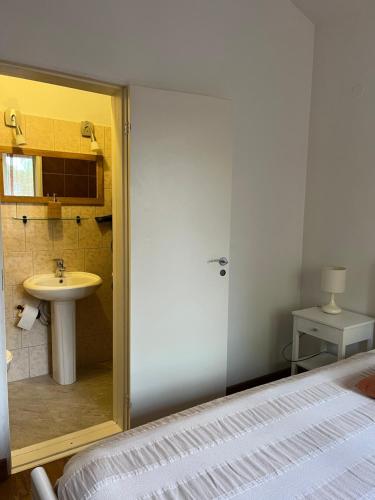 a bathroom with a bed and a sink at Apartamentai Palangos Centre in Palanga