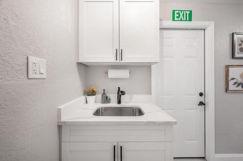 a bathroom with a sink and a white cabinet at Charming Updated Condo in Heart of Tampa in Tampa