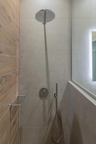 a shower with a shower head in a bathroom at Viva Mare Studios in Astypalaia Town