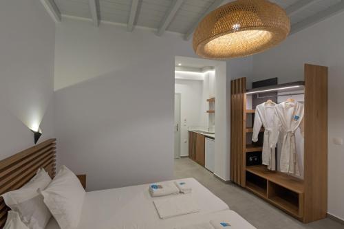 a bedroom with a bed and a closet with a robe at Viva Mare Studios in Astypalaia Town