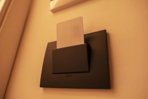 a lightswitch on a wall with a box on it at Da Placida Al Mare - Luxury B&B Soverato in Soverato Marina