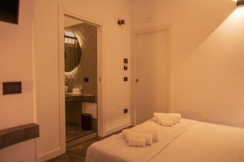 a bedroom with a bed with a sink and a mirror at Da Placida Al Mare - Luxury B&B Soverato in Soverato Marina