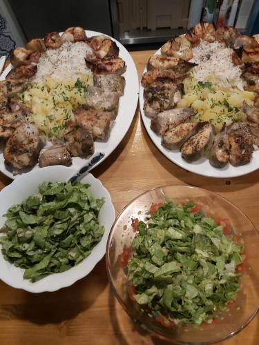 three plates of food on a wooden table with vegetables at Agropensiunea Beluga in Gorgova