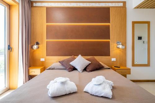 a bedroom with two towels on a bed at Hotel Mare in Lignano Sabbiadoro