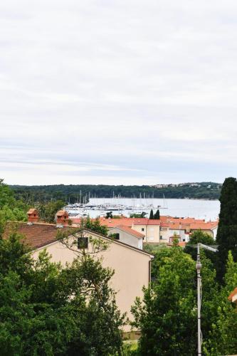 a view of a city with a boat in the water at Freya's Apartments Medulin in Medulin