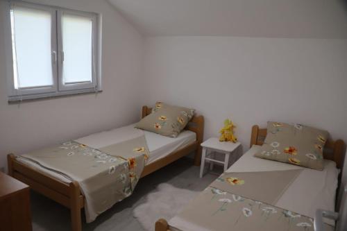 Habitación con 2 camas y ventana en Holiday Home Smile, en Bihać