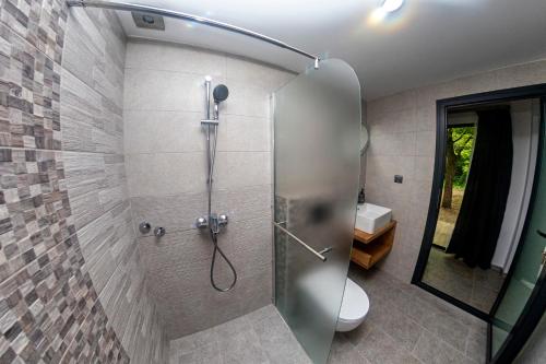 a shower with a glass door in a bathroom at Ecopark Tuzlata Екопарк Тузлата in Balchik