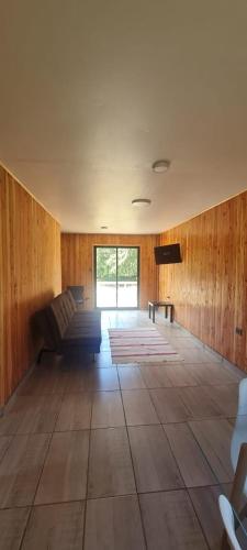 a large room with a couch and a television at Cabañas de la Barra in Villarrica