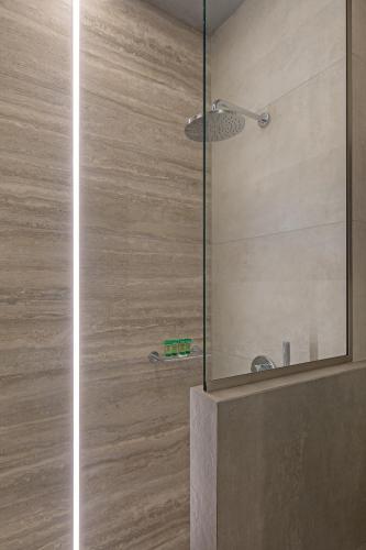 a shower with a glass door in a bathroom at Viva Mare Studios in Astypalaia Town