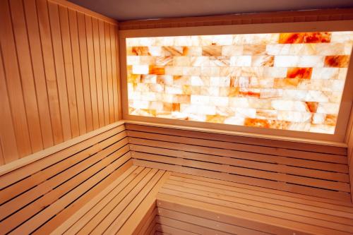 a sauna with a stone wall at Hotel Freya in Struga
