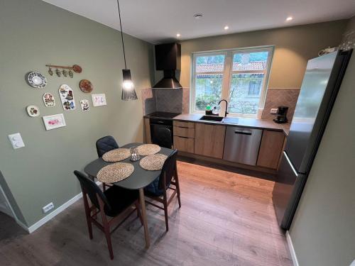 a kitchen and dining room with a table and chairs at Frafjord Apartments Frøya in Dirdal