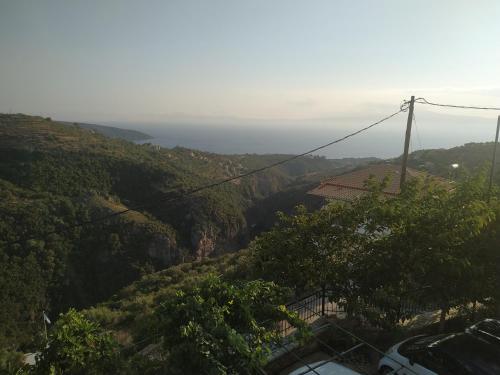 a view of a mountain with the ocean in the background at Papadeas Villas in Megáli Mandínia