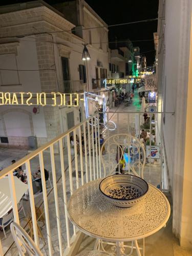 a table and chairs on a balcony at night at IL GELSO BIANCO Luxury apartments in Polignano a Mare
