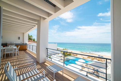 a balcony with a view of the ocean at Beachfront Flats Los Cabos in San José del Cabo