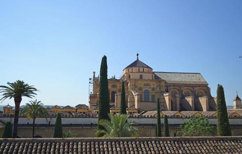 a large building with trees in front of it at Hotel Marisa in Córdoba