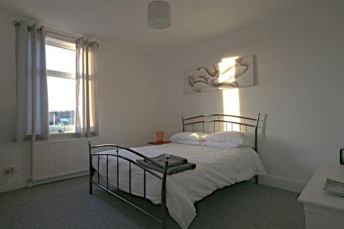 a bedroom with a bed and a window at Charming 3-Bed House in Whitwell village in Worksop