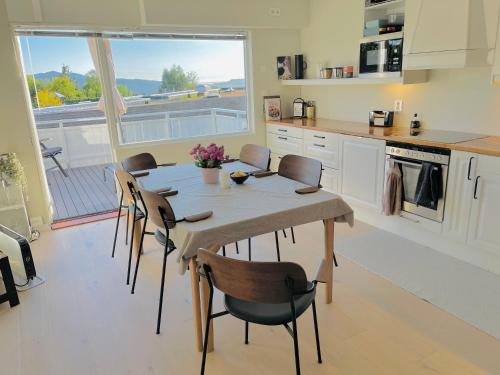 a kitchen with a table and chairs in a kitchen at Floien City House -free parking in Bergen