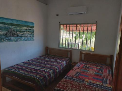 a bedroom with two beds and a window at El ensueño in San Bernardo del Viento