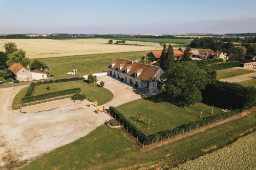 an aerial view of a large house in a field at GITE ENTRE TERRES ET VIGNES à la ferme avec SPA privatif en CHAMPAGNE à une heure de Paris in Châtillon-sur-Morin