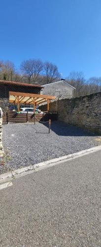 a park with a wooden pavilion on the side of a road at Cier de Riviere "Les Cerfs" in Cier-de-Rivière