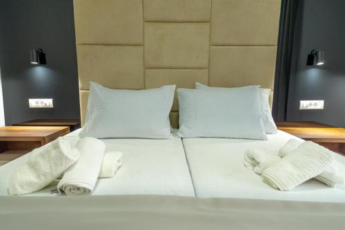 a large white bed with two towels on it at RIBAR APARTMENTS in Ohrid