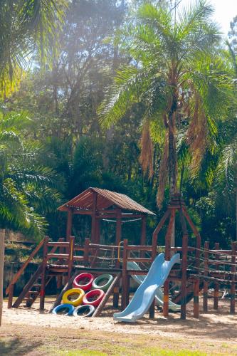 a playground with a slide and a slideintend at Rio Quente Resorts - Eco Chalés in Rio Quente