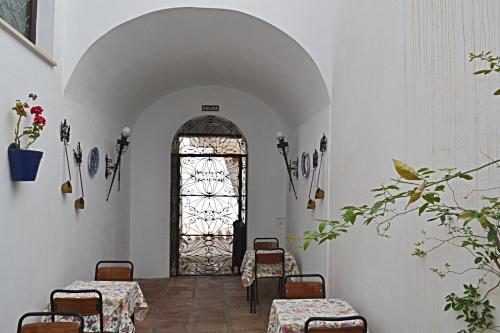 a room with a table and chairs and a window at Hotel Marisa in Córdoba