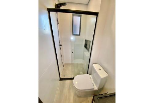 a bathroom with a toilet and a shower at APTO Studios in Itajaí