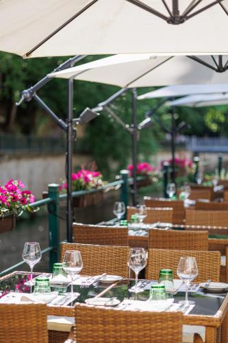 a group of tables with wine glasses on them at Villa Basileia Riverside in Karlovy Vary