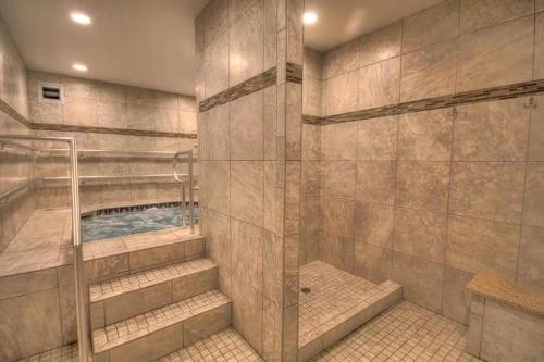 a bathroom with a walk in shower and a walk in shower at El Matador- Beachside Haven 210 in Fort Walton Beach