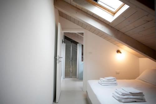 a bedroom with a bed with towels on it at Cibrario Cit Apartment_Square in Turin