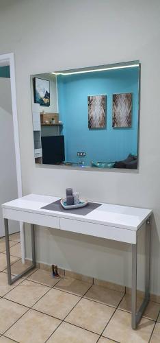 a white table with a mirror on a wall at Nina Apartment in Chania Town