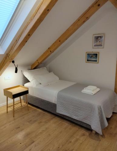 a bedroom with two beds in a attic at Villa Cutty sark in Maslinica