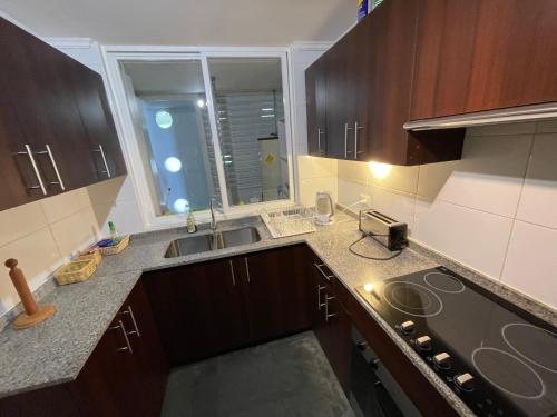 a kitchen with a sink and a counter top at Neohaus vista insuperable in La Serena