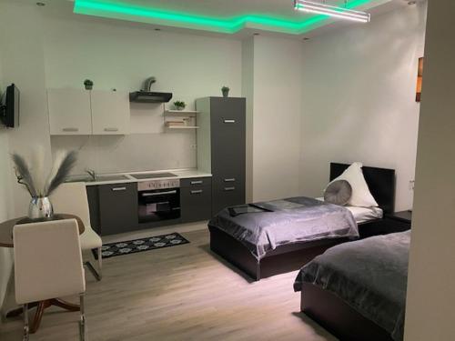 a bedroom with a bed and a desk and a table at N-City in Magdeburg