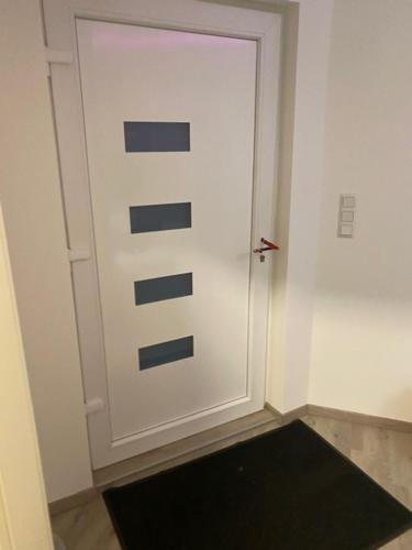 a white door with a black rug in front of it at N-City in Magdeburg
