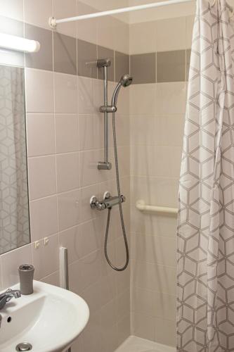 a bathroom with a shower and a sink at Villa Saint Fort - Résidence Services in Saint-Fort