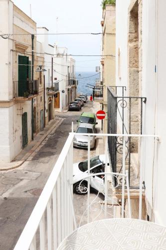 a view of a street with cars parked on a balcony at IL GELSO BIANCO Luxury apartments in Polignano a Mare