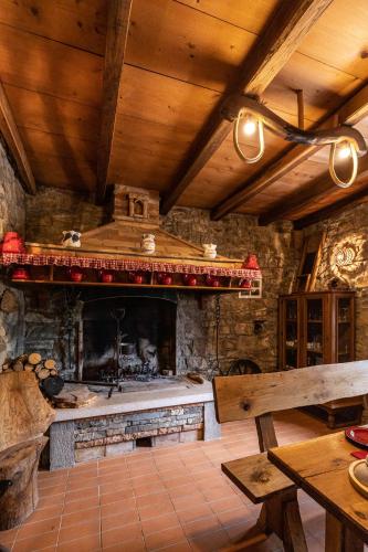 a kitchen with a fireplace and a wooden ceiling at Rašpor in Rašpor